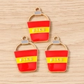 Close-up of three fire bucket charms with red enamel and FIRE text on wood background - Fire Bucket