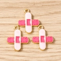 Detail of band-aid shaped enamel alloy pendants with gold plating for jewelry making - Pink