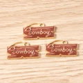 Close-up of brown enamel cowboy pendants with gold lettering for DIY jewelry making - Cowboy Sign Tag / 10 Pieces Pack / Brown