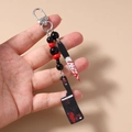 Detail of bloody horror knife keychains with red and black beads for Halloween - Bloody Cleaver Style