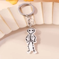 Detailed view of the cute acrylic skeleton pendant on a silver metal keychain - Skull