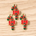Macro shot of colorful enamel Christmas candy cane pendants with red bow for DIY jewelry making - 10 Pieces Pack / Christmas Red And Green Candy Cane