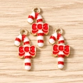 Detail of red and white striped Christmas cane charms with bow and gold metal plating - 10 Pieces Pack / Christmas Red And White Candy Cane