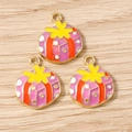 Detailed macro view of pink enamel gift box charms with golden alloy metal for DIY jewelry - 10 Pieces Pack / Christmas Pink Gift Box