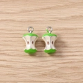 Detail view of apple core enamel pendants with green skin and silver metal rings - 5 Pieces / Silver Green Apple
