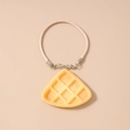 Detailed view of a realistic waffle pendant charm with beige woven cord and silver clasp - Waffle