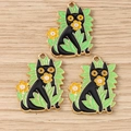 Detailed macro view of three enamel black cat charms with yellow flowers and green leaves - Cat Style / 10 Pieces Pack / Yellow-Green