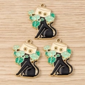 Detailed view of three enamel black cat pendants with green flower charms and gold plating - Potted Cat Style / 10 Pieces Pack / Black