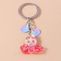 Detailed close-up of a pink resin octopus keychain with crown and iridescent shells - Octopus