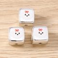 Macro shot of silver cube beads with white puppy charms and red bows for DIY jewelry - 5 Pieces / Puppy Square Bead