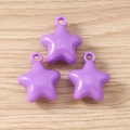 Three purple star-shaped resin pendants with glossy finish on a natural wooden background - 5 Pieces / Purple