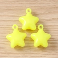 Close-up of three fluorescent yellow star pendants with integrated rings for DIY jewelry - 5 Pieces / Yellow