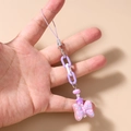 Detalle de correa para móvil con cuenta de estrella púrpura y lazo con motas colgante - Morado