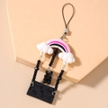 Detail of beaded mobile strap with rainbow charm, black bear pendant and bow element - Black
