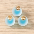 Close-up of three blue frosted spherical charms with golden loops on wooden background - 10 Pieces Pack / Blue