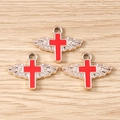 Detailed view of three red enamel angel wing cross pendants with silver alloy base - 10 Pieces Pack / Red