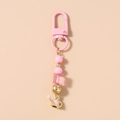 Bijou de téléphone perlé rose avec breloque arrosoir doré et détails de cœur roses - Porte-clés Arrosoir Perles Roses