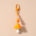Detail of orange mushroom keychain with white polka dots and striped beads charm - Orange