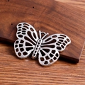 Detailed macro view of an antique silver hollow butterfly pendant for DIY jewelry making - Silver