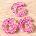 Close-up of pink glitter letter G resin pendants with silver loops for jewelry making - 5 Pieces / Letter G