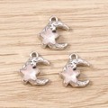 Macro detail of crescent moon and star charms with pink shell texture and silver base - Silver Pink