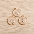 Detailed view of three golden irregular coin charms with embossed portraits on wood background - 10 Pieces Pack / Gold