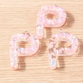 Macro detail of letter P resin charms with pink iridescent shell fragments for DIY jewelry - 5 Pieces / Letter P
