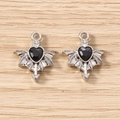 Macro shot of silver gothic bat wing pendants with black heart-shaped faceted gems - 5 Pieces / Silver Black