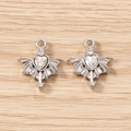 Macro shot of silver winged heart charms with clear cubic zirconia on wooden surface - 5 Pieces / Silver
