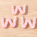 Close-up of pink iridescent resin letter W charms for DIY jewelry with silver metal rings - 5 Pieces / Letter W