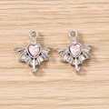 Macro detail of gothic bat wing heart charms with pink gemstone for DIY jewelry making - 5 Pieces / Silver Pink