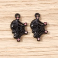 Detailed macro view of black skull spider web pendants with pink rhinestone accents - 5 Pieces / Black Pink