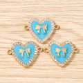 Detail view of light blue heart pendants with golden bows and rhinestone borders - 10 Pieces Pack / Gold Blue