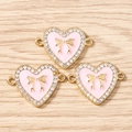 Detailed view of pink enamel heart pendants with golden bows and sparkling rhinestones - 10 Pieces Pack / Gold Pink