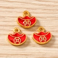 Detailed view of three gold-plated yuanbao fortune pendants with red enamel finish - Coin Sycee Style / 10 Pieces Pack