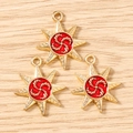 Detailed view of three gold eight-pointed star charms with red spiral centers on wood - 10 Pieces Pack / Gold Red
