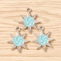 Macro shot of silver eight-pointed star pendants with light blue enamel for DIY jewelry - 10 Pieces Pack / Silver Blue
