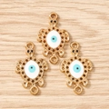 Detailed macro view of three gold turtle charms with evil eye pattern for DIY jewelry - 10 Pieces Pack / Gold White
