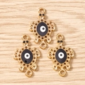 Detailed view of turtle-shaped connectors with evil eye enamel for DIY jewelry making - 10 Pieces Pack / Gold Black