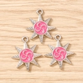 Macro detail of silver-tone octagonal star pendants with pink resin inlay on wood background - 10 Pieces Pack / Silver Rose Red