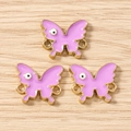 Macro detail of purple butterfly charms with eye pattern and golden metal loops - 10 Pieces Pack / Gold Purple