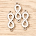 Macro view of silver-plated number 8 enamel charms on wood background for jewelry DIY - Set of 3 / Silver