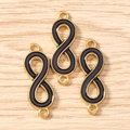 Macro shot of three gold infinity charms with black enamel inlay on wood background - Set of 3 / Gold Black