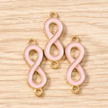Close-up of pink enamel infinity sign charms with gold metal base for jewelry making - Set of 3 / Gold Pink