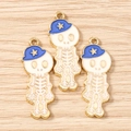Detalle de colgantes de calavera dorada con sombreros de estrella azul para joyas DIY - Paquete de 10 / Oro Blanco Azul Oscuro