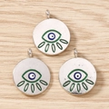 Macro detail of evil eye pendants with blue eye and green lashes for DIY jewelry making - 10 Pieces Pack / Silver Green
