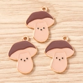 Detail view of mushroom charms with brown caps and gold plating for DIY jewelry projects - Mushroom / 10 Pieces Pack