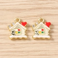 Détail de breloques maison en émail coloré avec strass sur fond bois clair - Doré