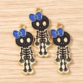 Detailed macro of dark cartoon skull charms with blue bow and gold-plated alloy finish - 10 Pieces Pack / Gold Black Dark Blue
