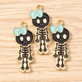 Macro shot of skull alloy charms with blue bows and gold accents on wood background - 10 Pieces Pack / Gold Black Blue